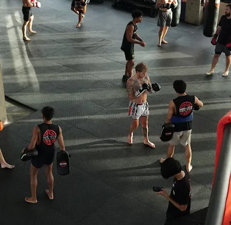 Fight club classes in Bali group session with students practicing guard technique indoors.