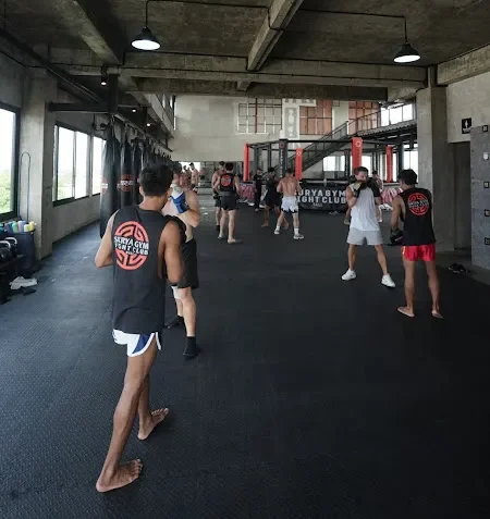 Coach guiding students inside Surya Gym during fight club classes in Bali workout program.